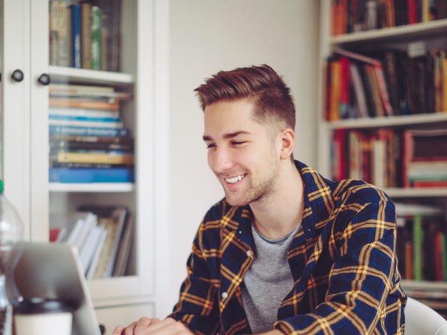 A man attending an online language class on his laptop