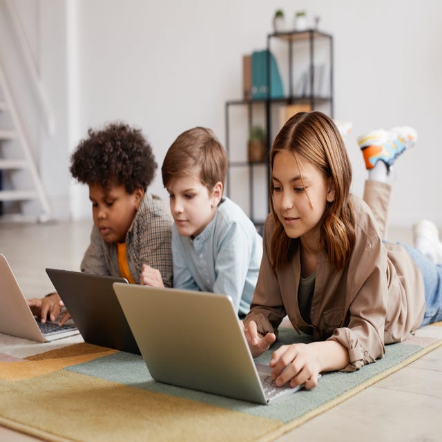 Three children attending an online class on their laptops