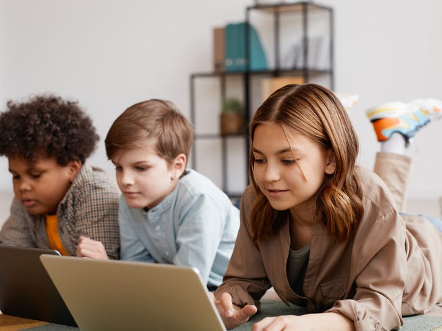 Three children attending an online class on their laptops