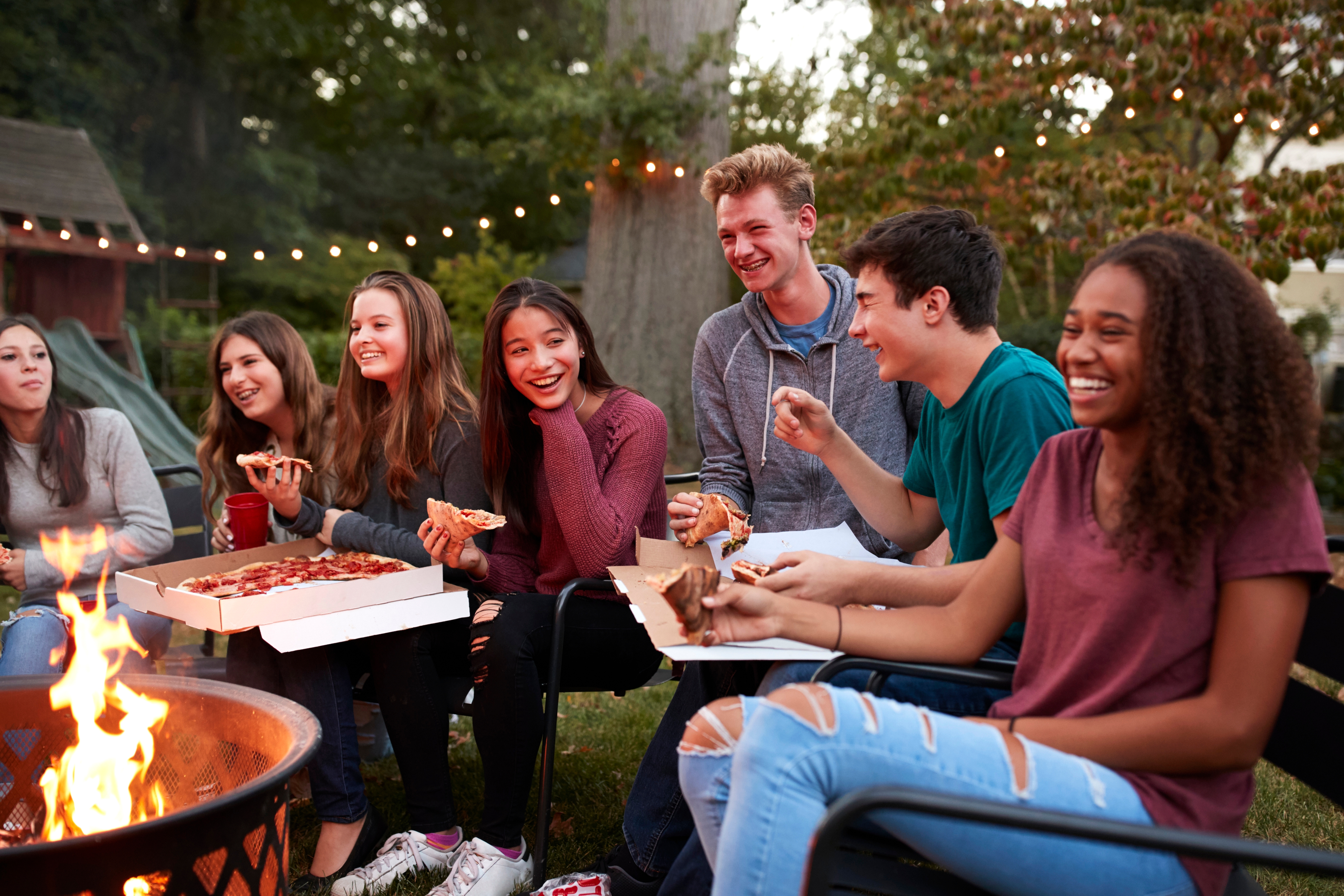A group of people in a garden party speaking in English