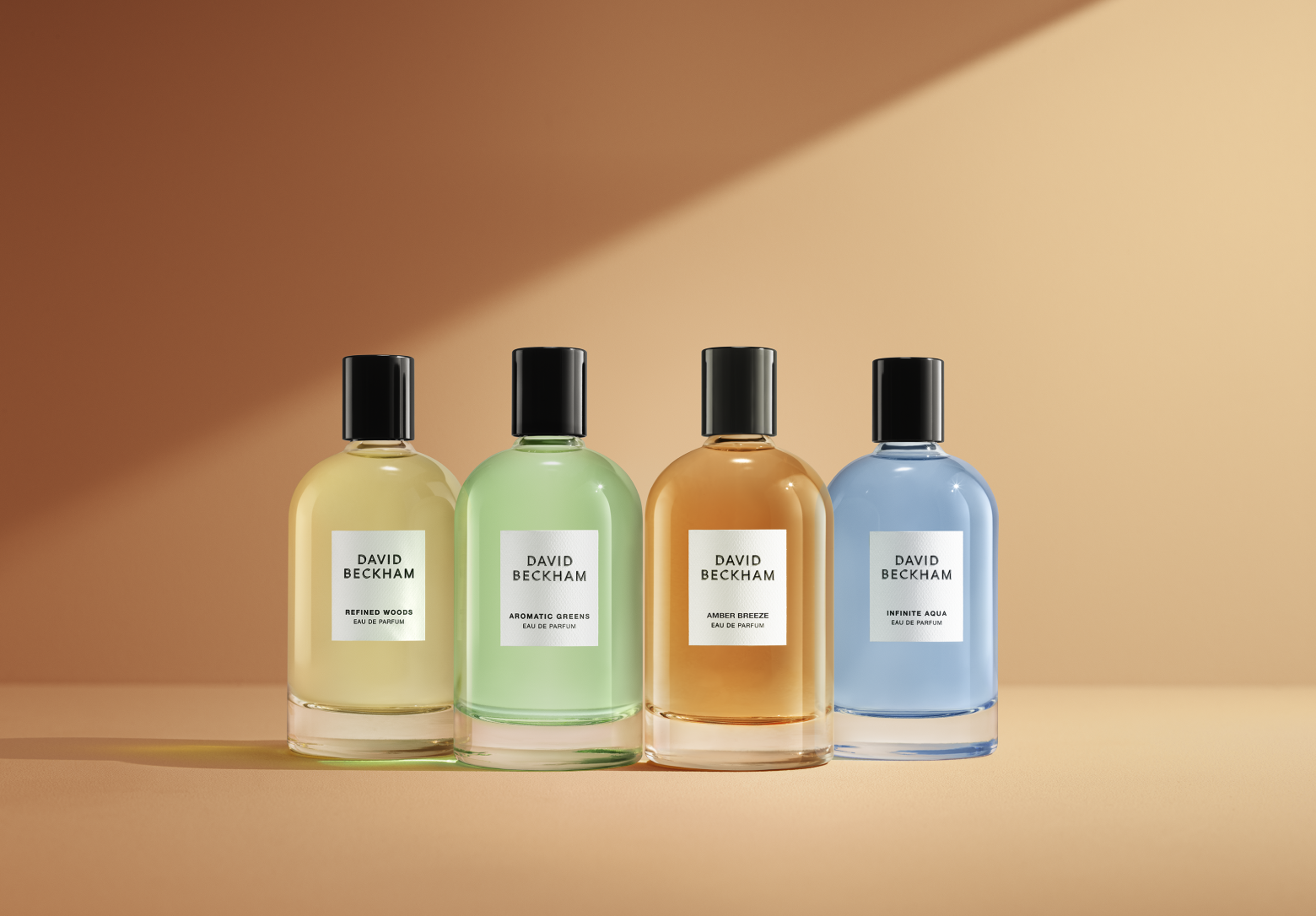 David Beckham Eau de Parfum collection featuring Refined Woods, Aromatic Greens, Amber Breeze, and Infinite Aqua bottles.
