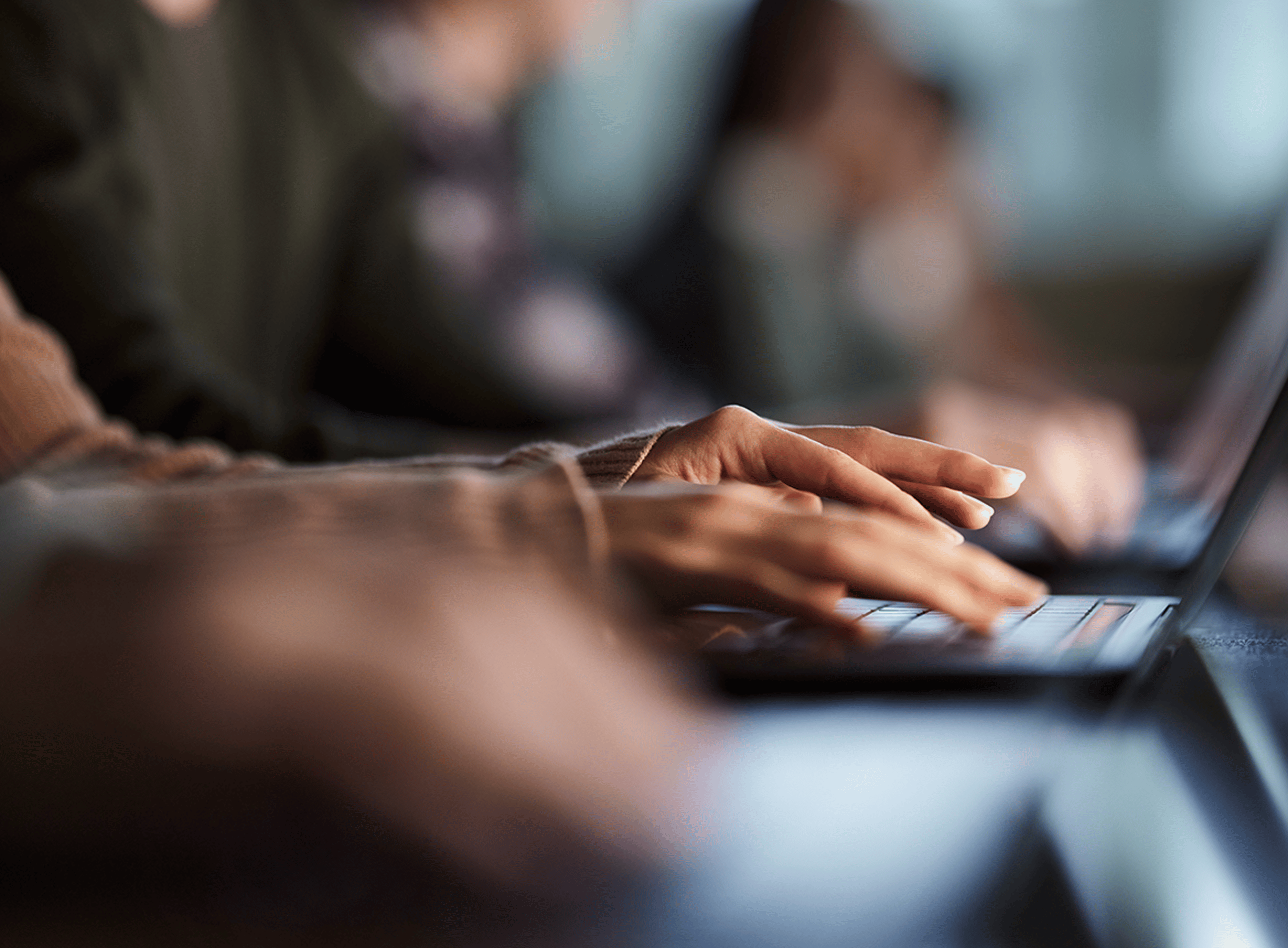 Hands typing on a keyboard