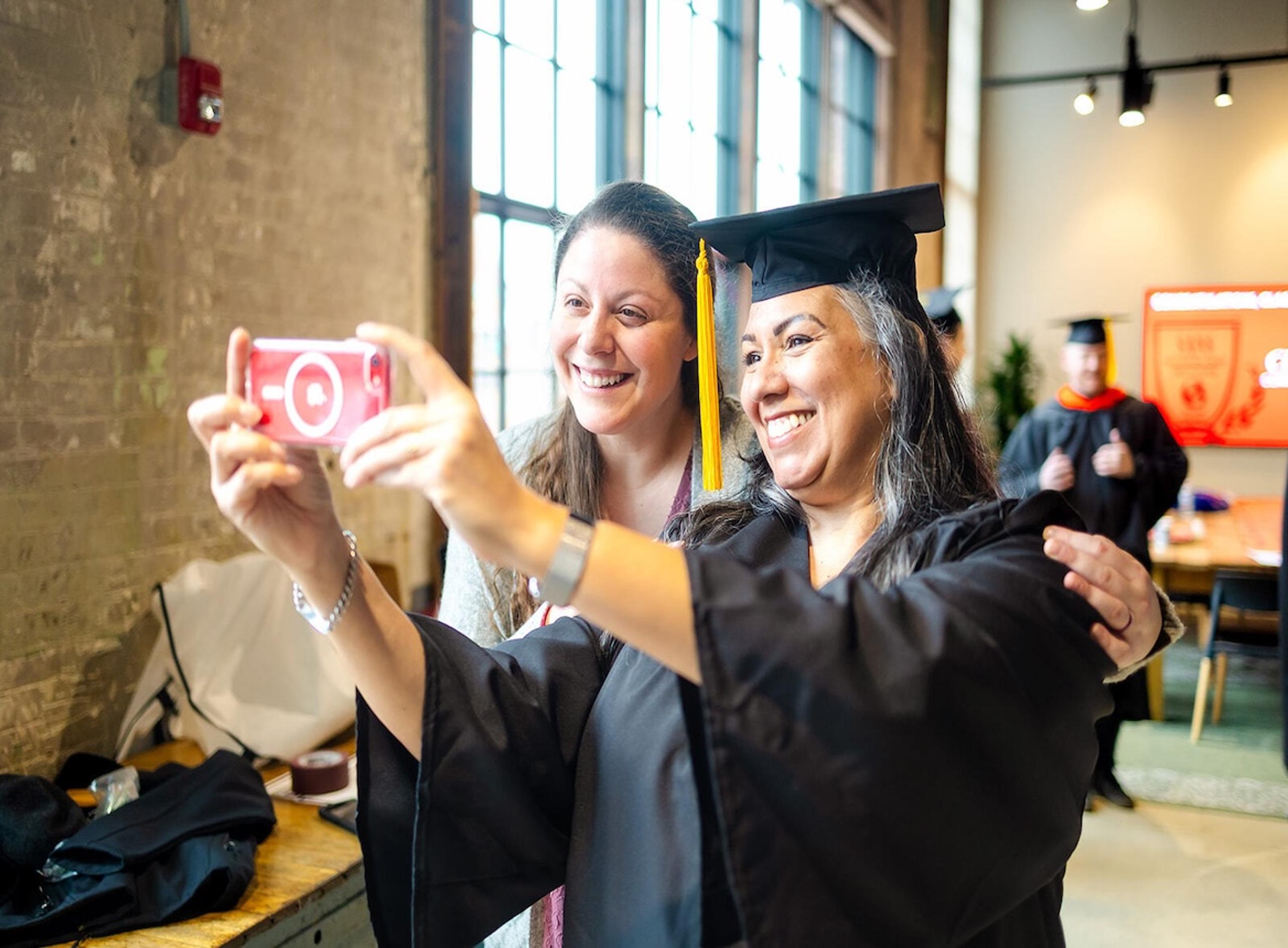 Two People Smiling at the 2025 Graduation Ceremony