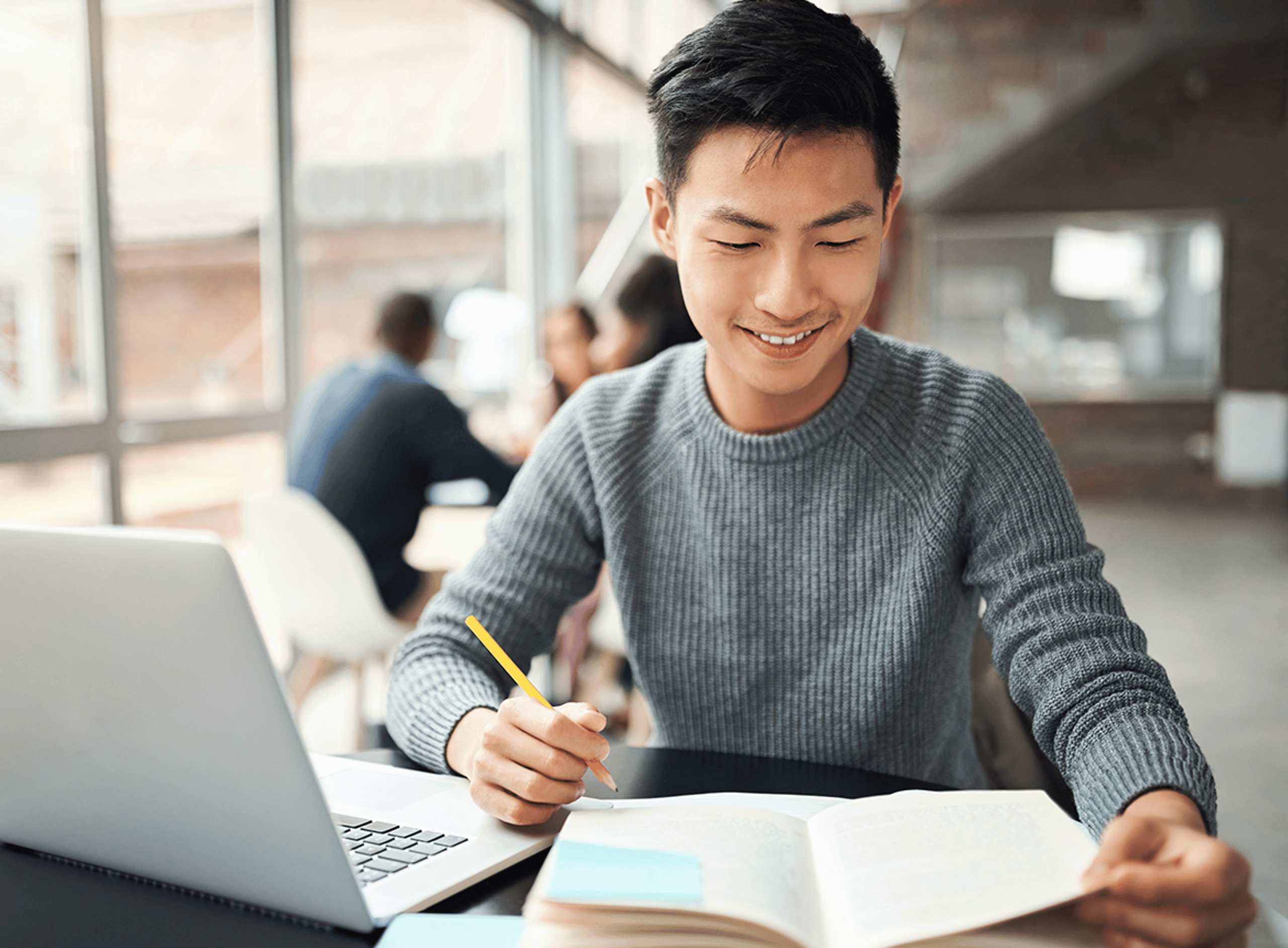 Male working at laptop with notepad