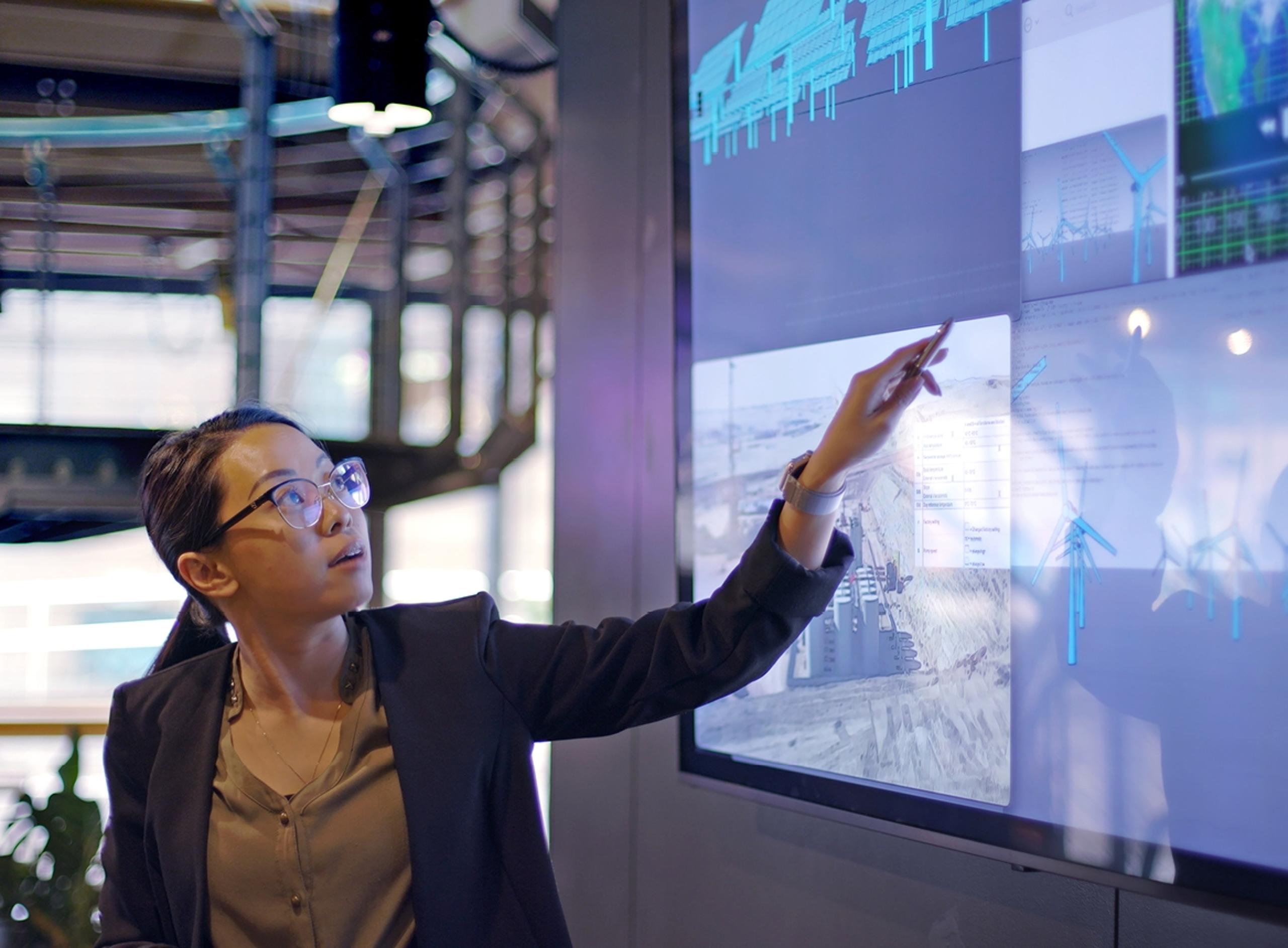 A Woman Pointing at Smartboard Full of Information