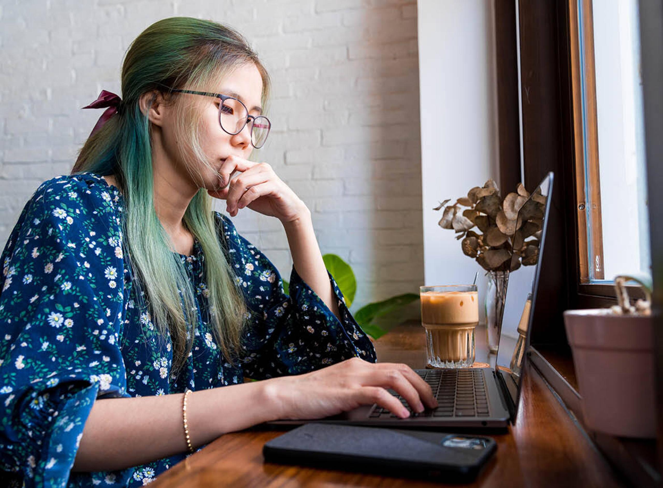 Woman Sitting at Laptop With Coffee