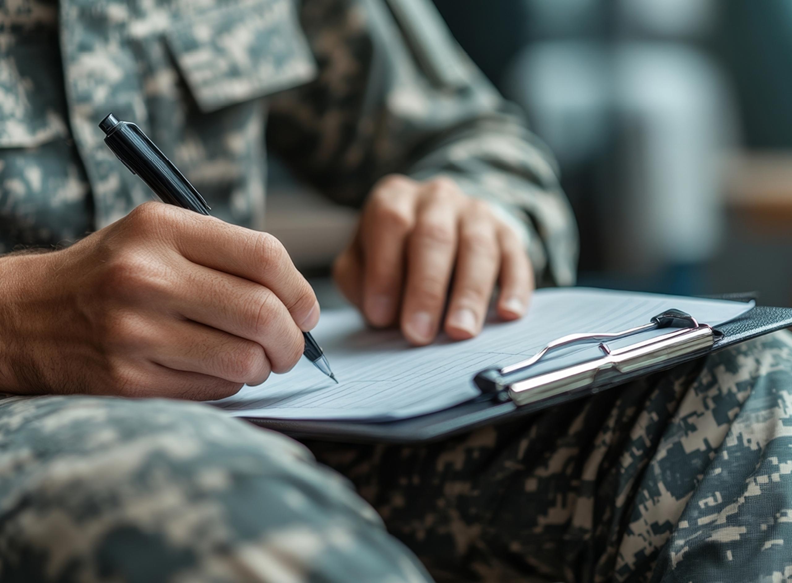 Close Up of Soldier Writing on Clipboard