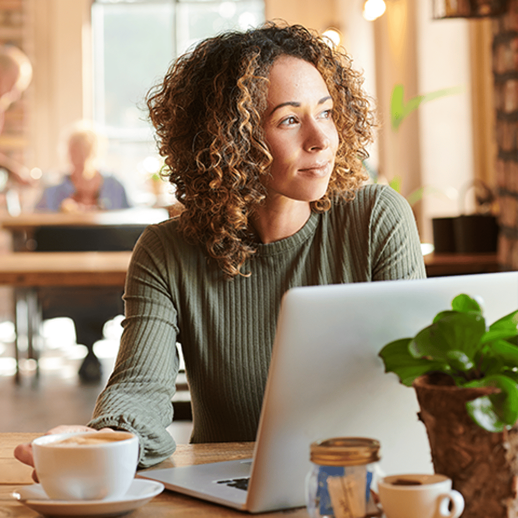 Woman working at desk with laptop