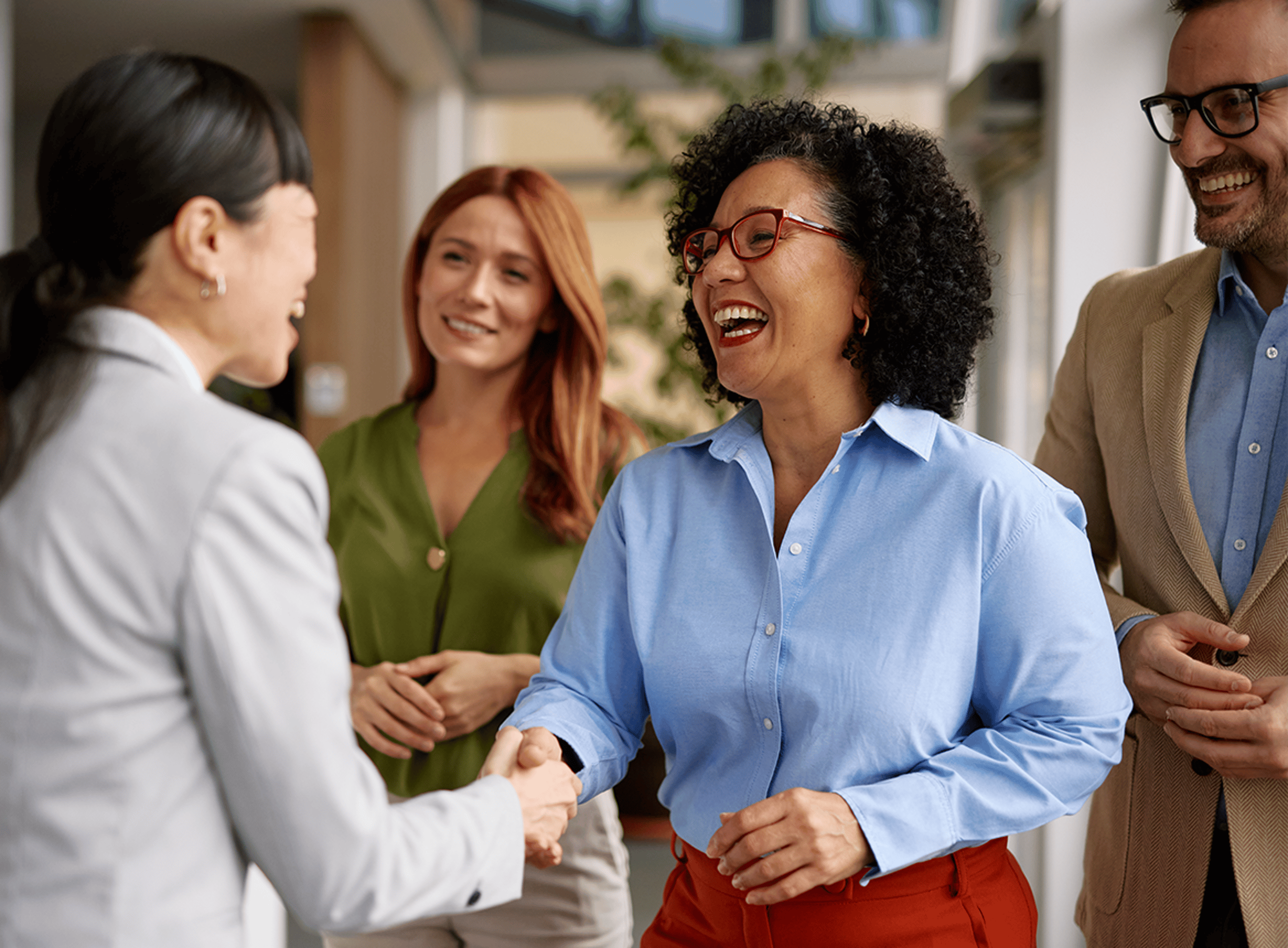 Two Women Shaking Hands and Laughing
