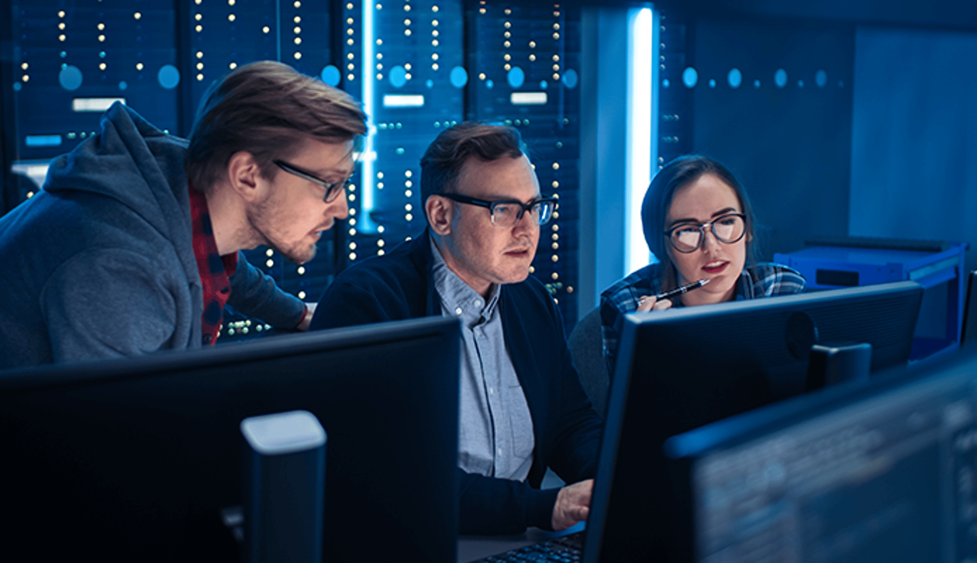 Three people working at computer