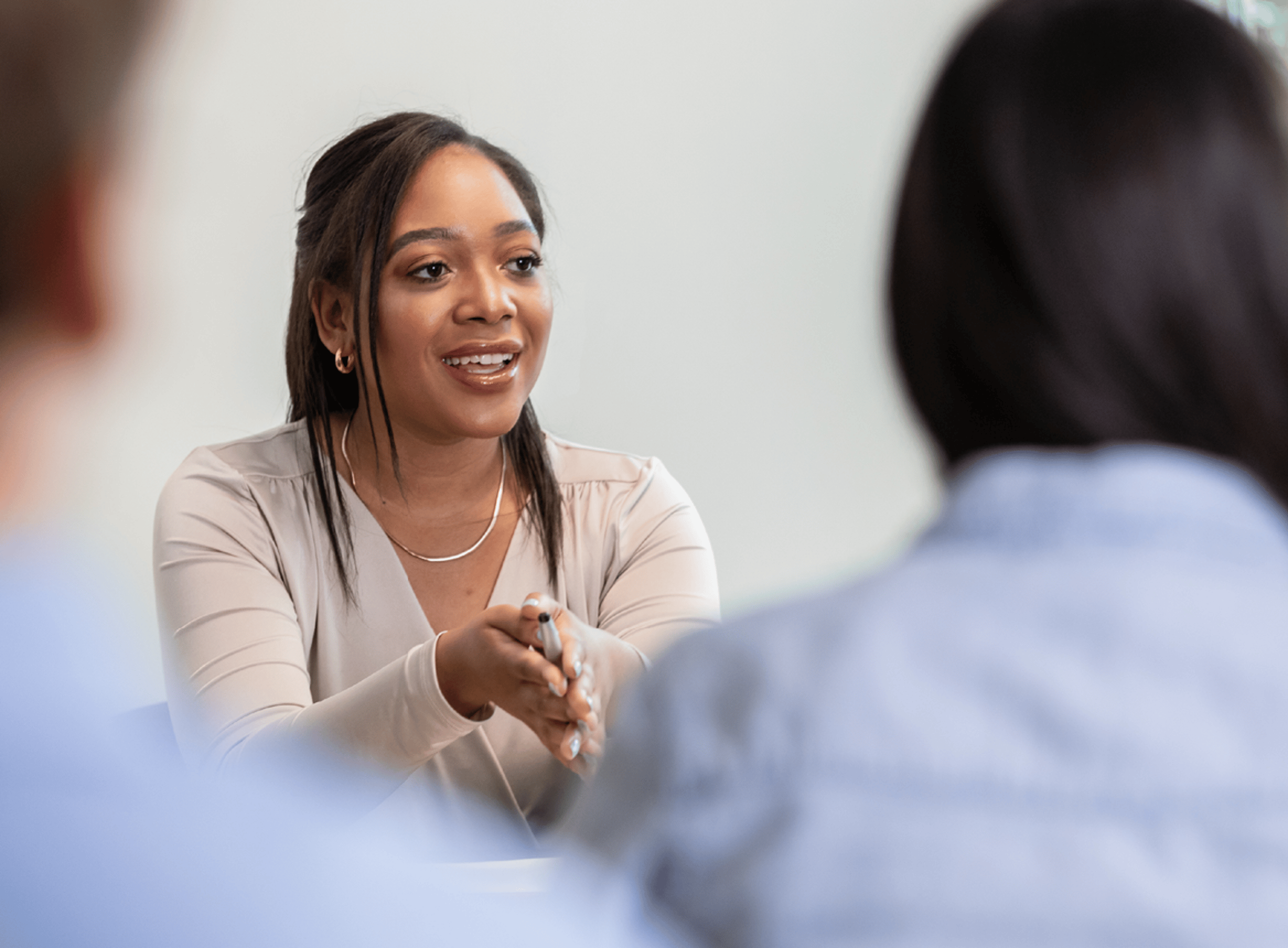 Woman Explaining a Point in a Meeting
