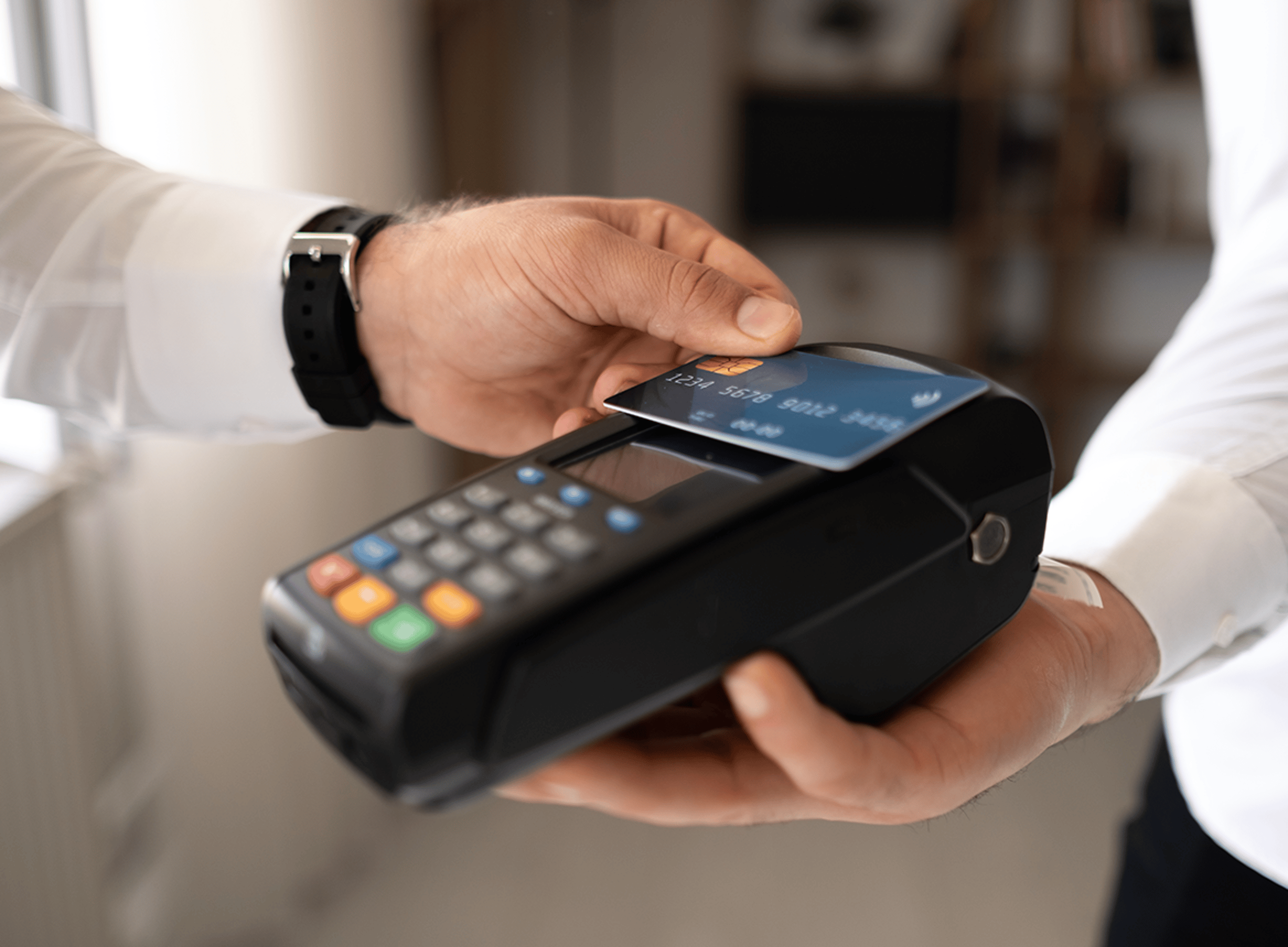 Close Up of Person Tapping Their Credit Card on Machine Reader