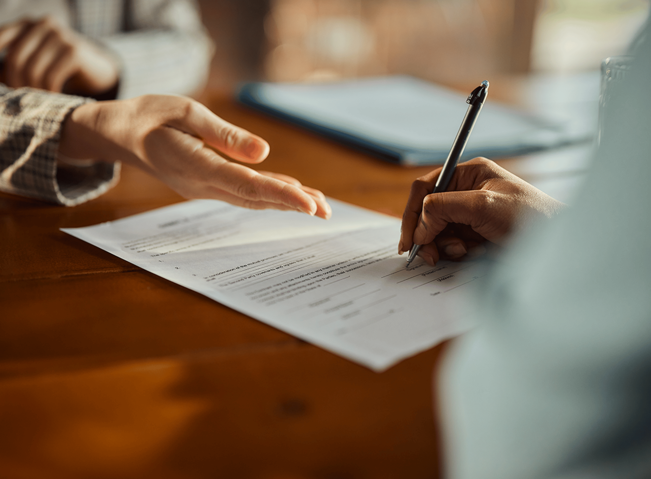 Close Up of a Person Signing a Form