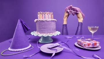 purple party hat and purple birthday cake with candles