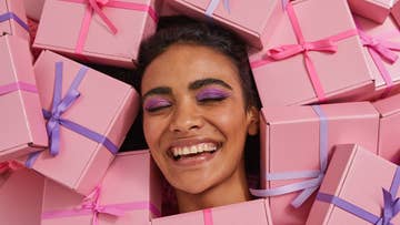 women surrounded by pink gift boxes