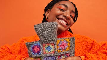 women holding a knitted waterbottle