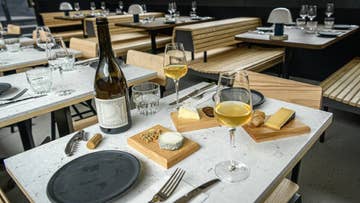 table with bottle of wine and cheese board