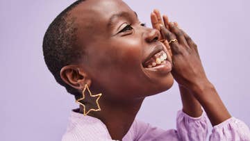 women wearing gold star shaped earrings