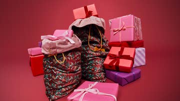 Christmas stockings surrounded by pink gift boxes