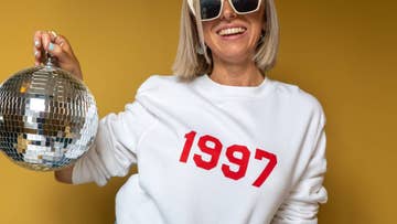 women wearing a white sweater with 1997 printed on the front