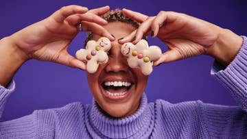 women holding two Gingerbread over her eyes