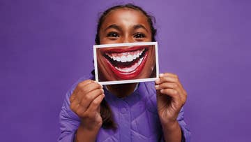 woman holding a smile picture