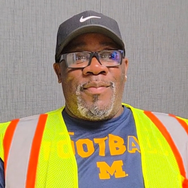 an owner-operator wearing a yellow and orange safety vest