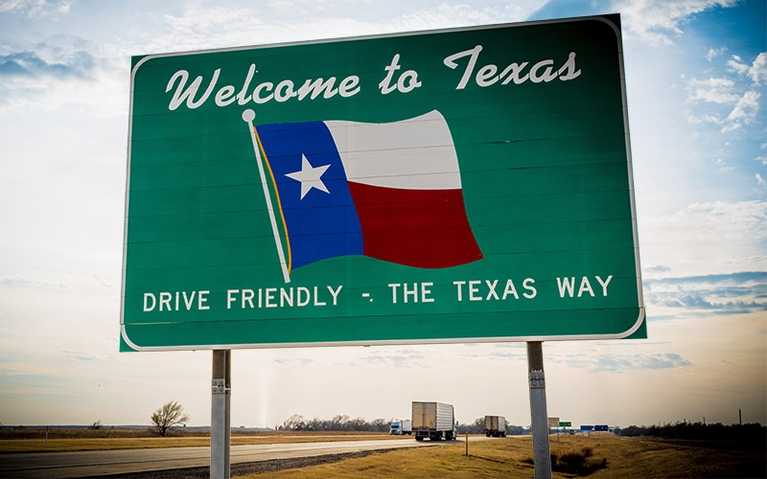 A "Welcome to Texas" sign off of an interstate.