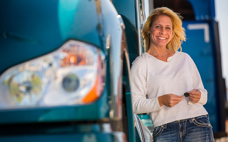 An owner-operator holds the keys to her new semi-truck