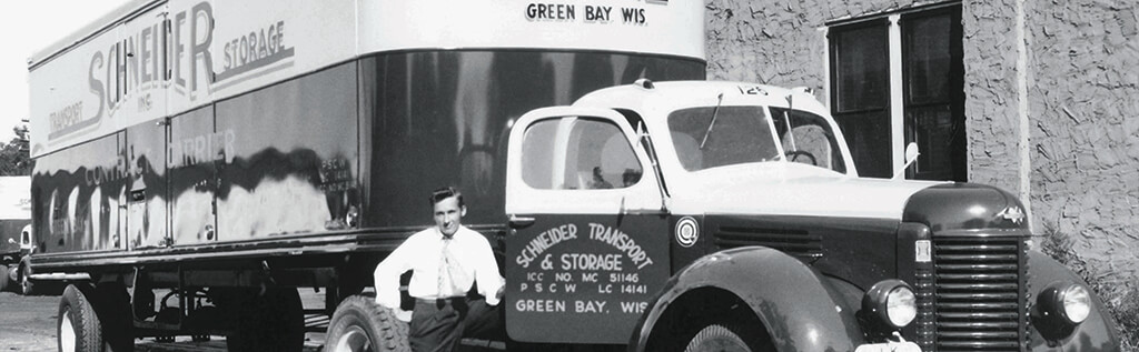 Al Schneider poses with one of Schneider's early truck models