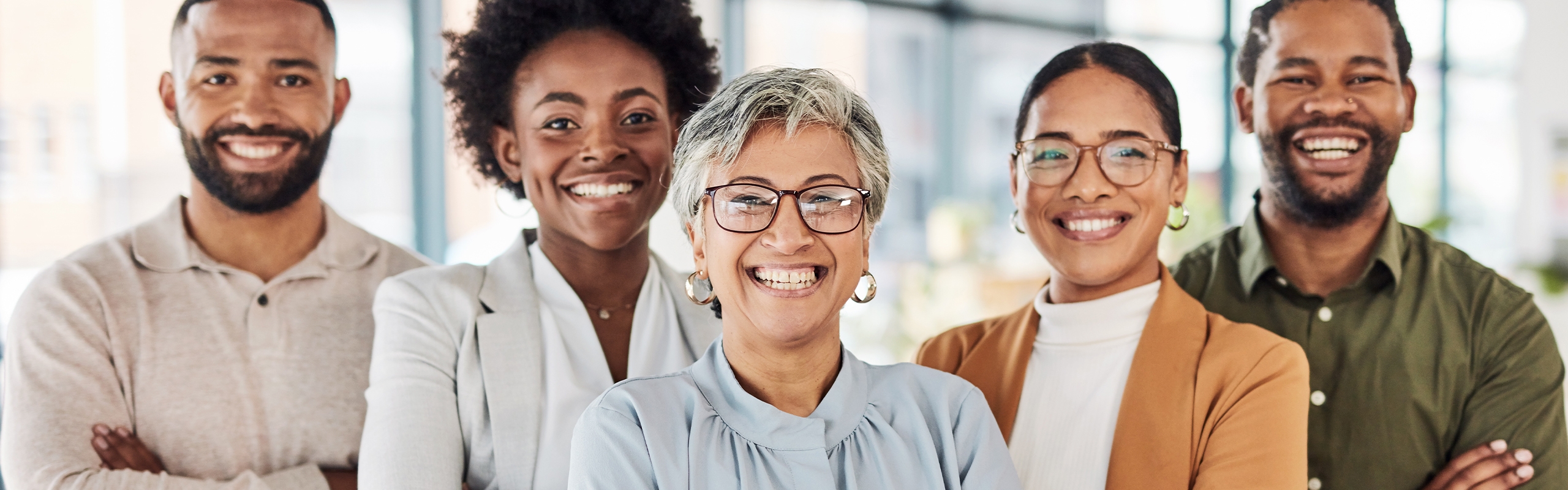 A group of peers smiling at the camera