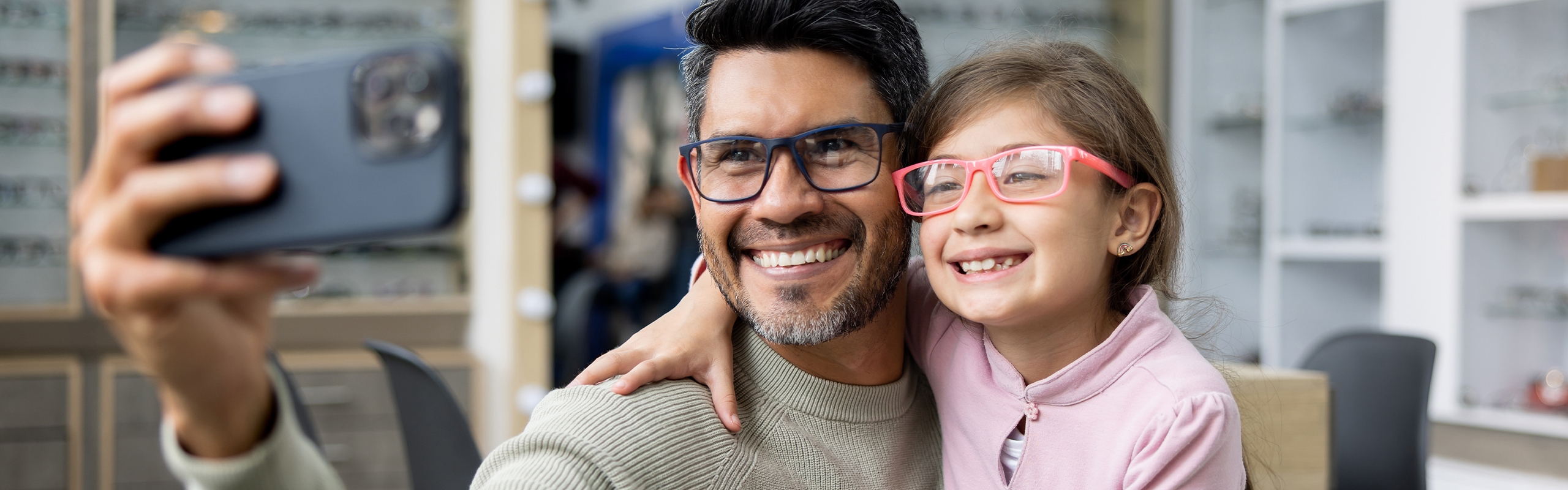 Father and daughter wearing glasses taking a selfie