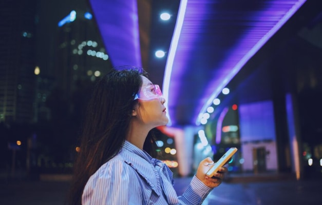 person holding phone looking up