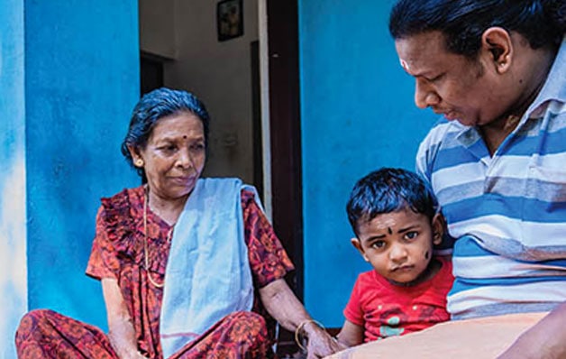 A family sitting outside a house