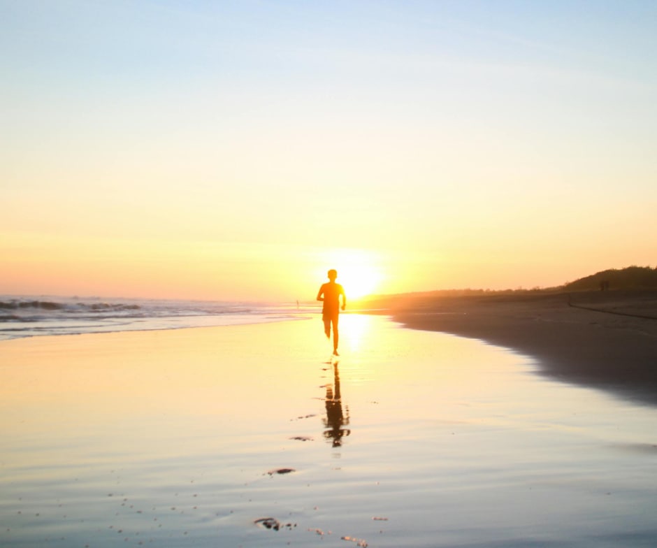 Person running outside in the sunset