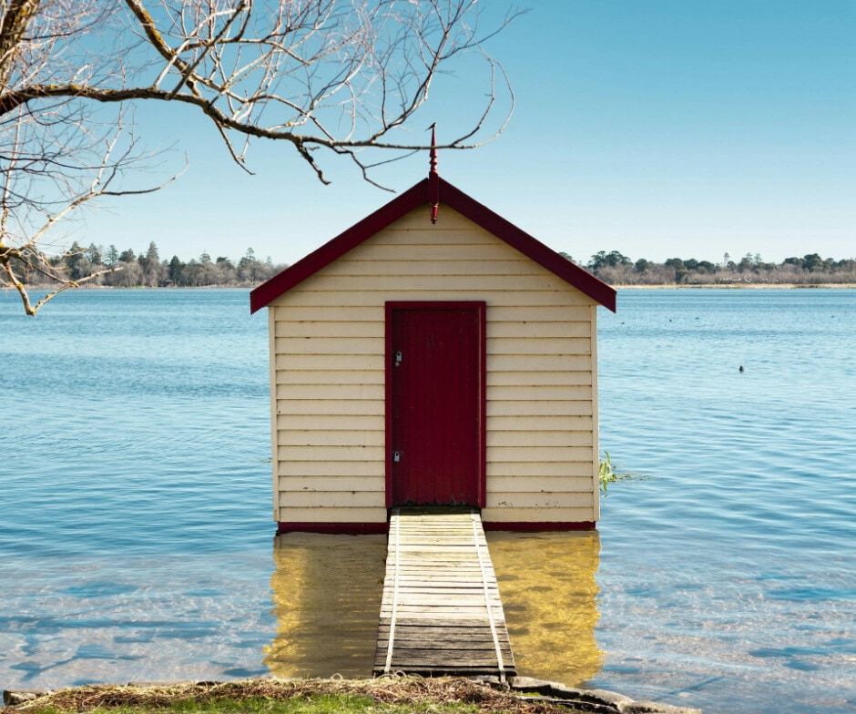 cabin house in front of lake