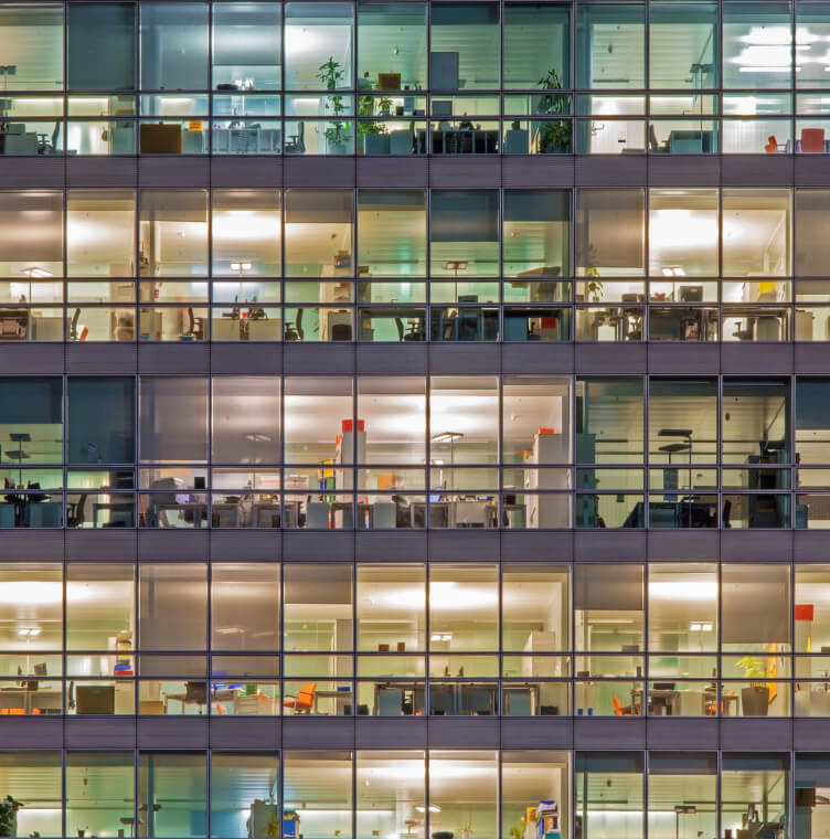Window of building showing many offices within