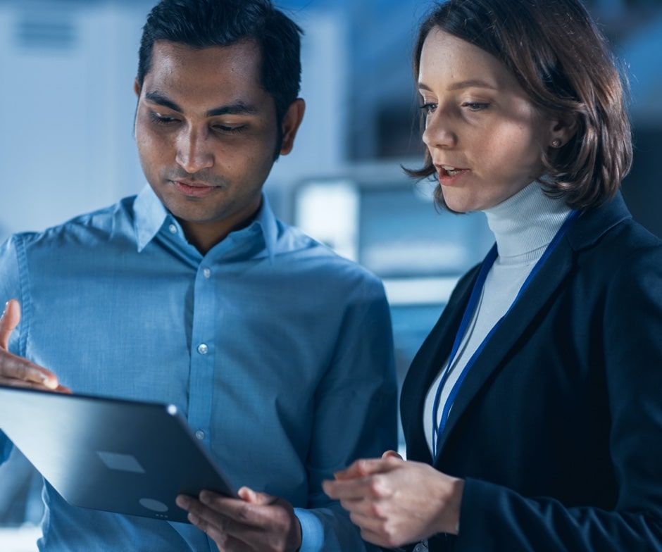 man and woman look at tablet