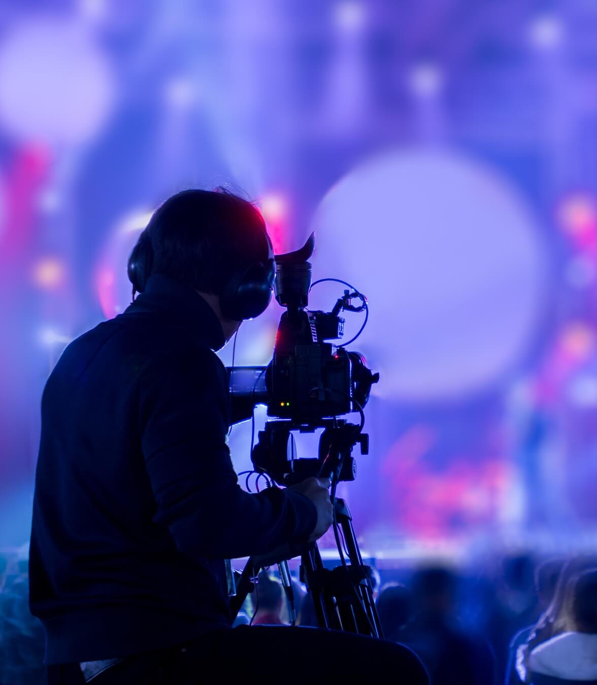 A filmmaker is recording and broadcasting live concerts