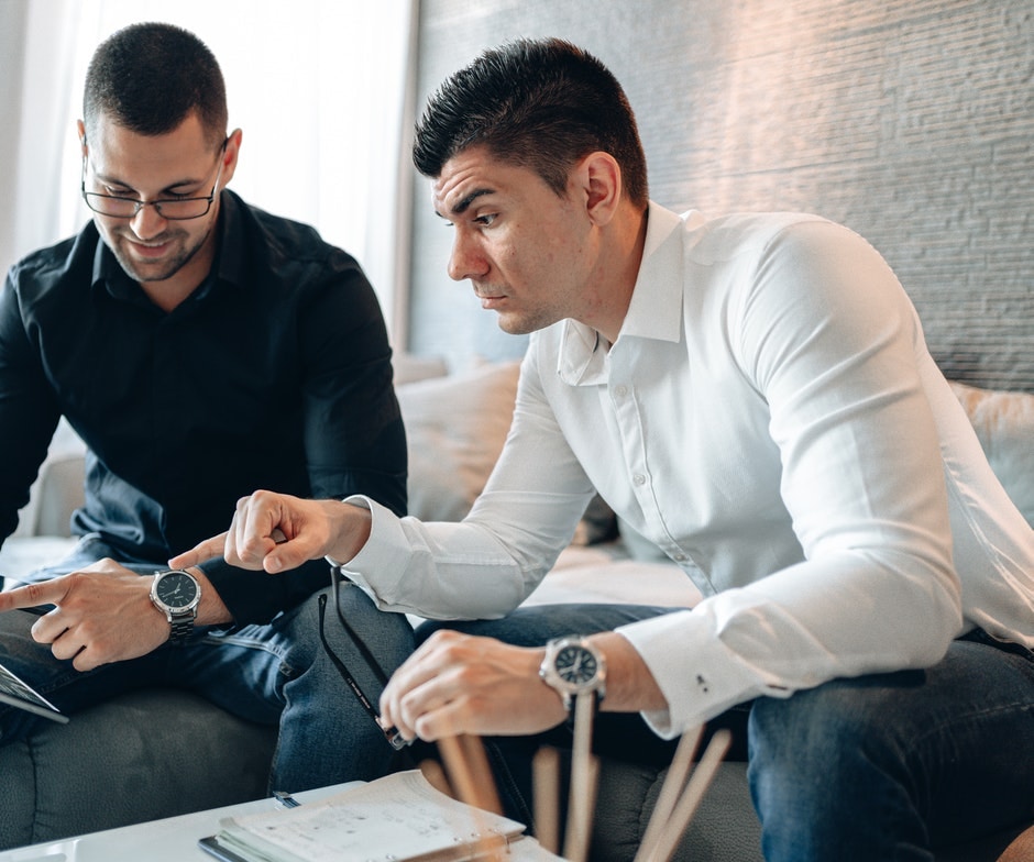 2 men looking at a tablet