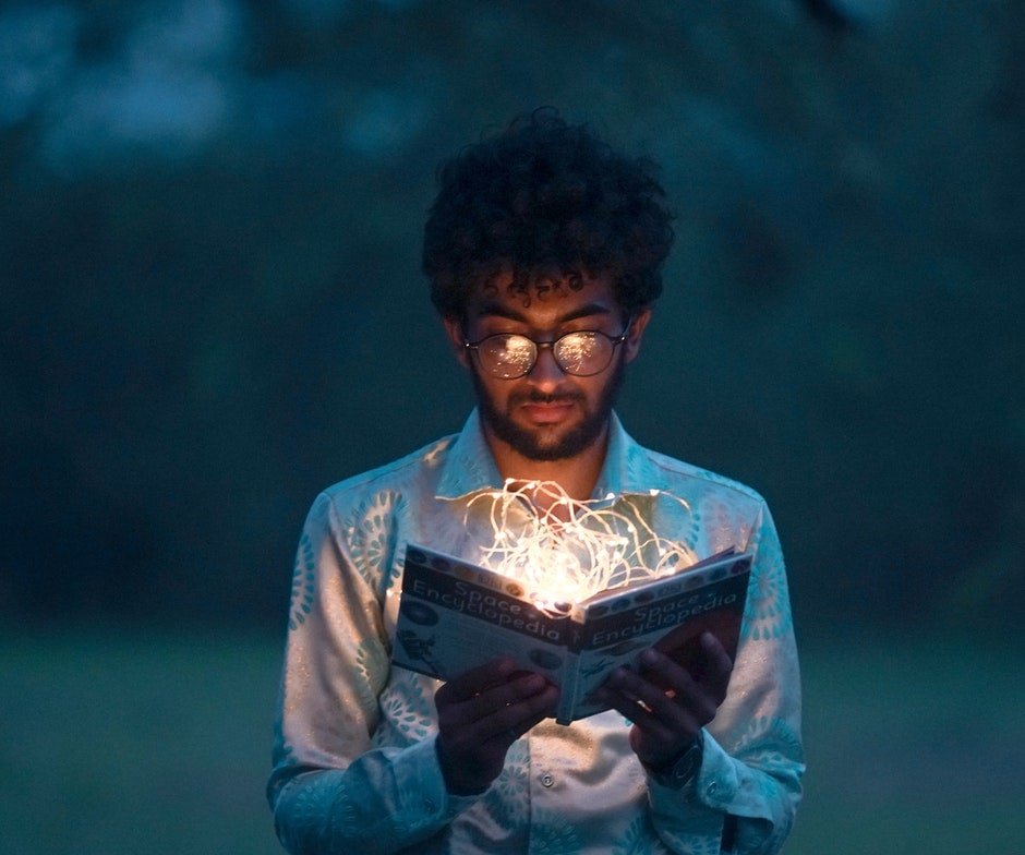 a man reading a book on fire