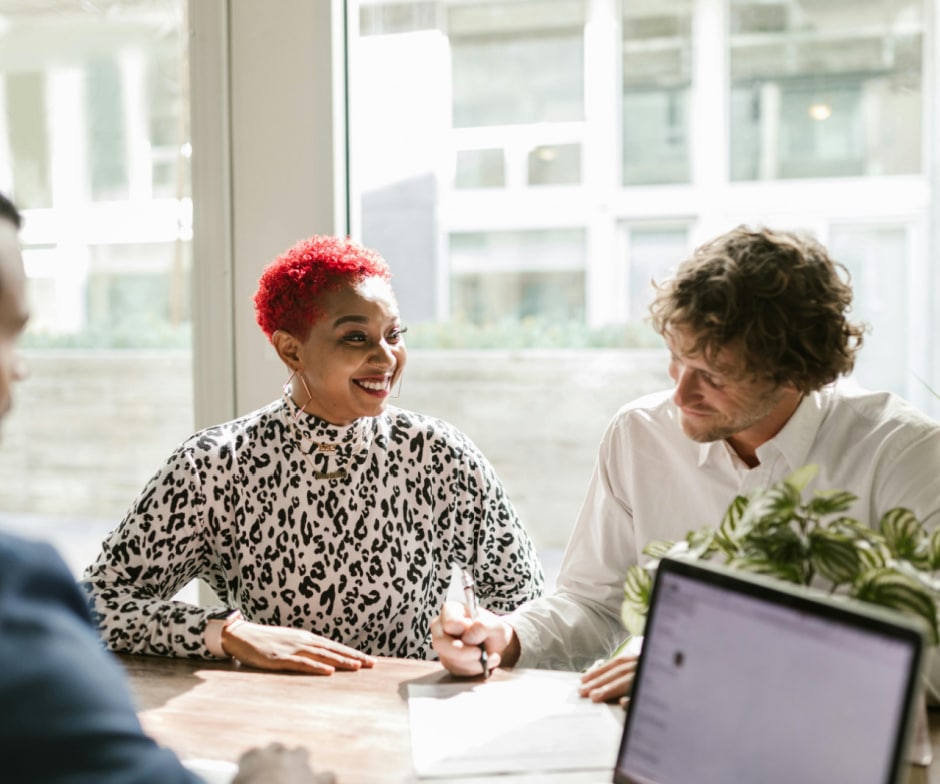 professionals sitting in conference room and laughing