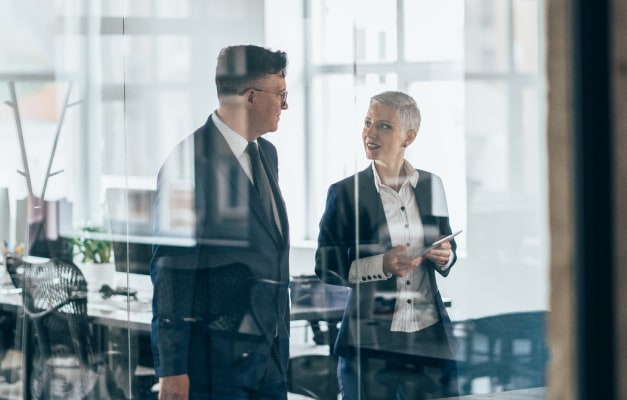 two people talking in a office