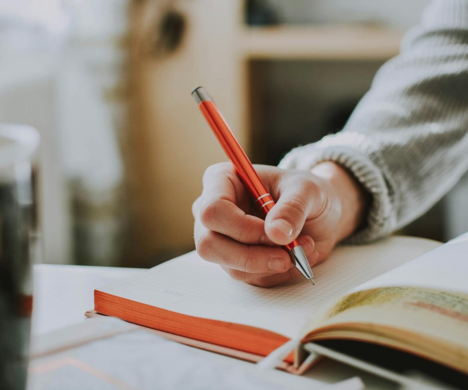 Person writing in the book