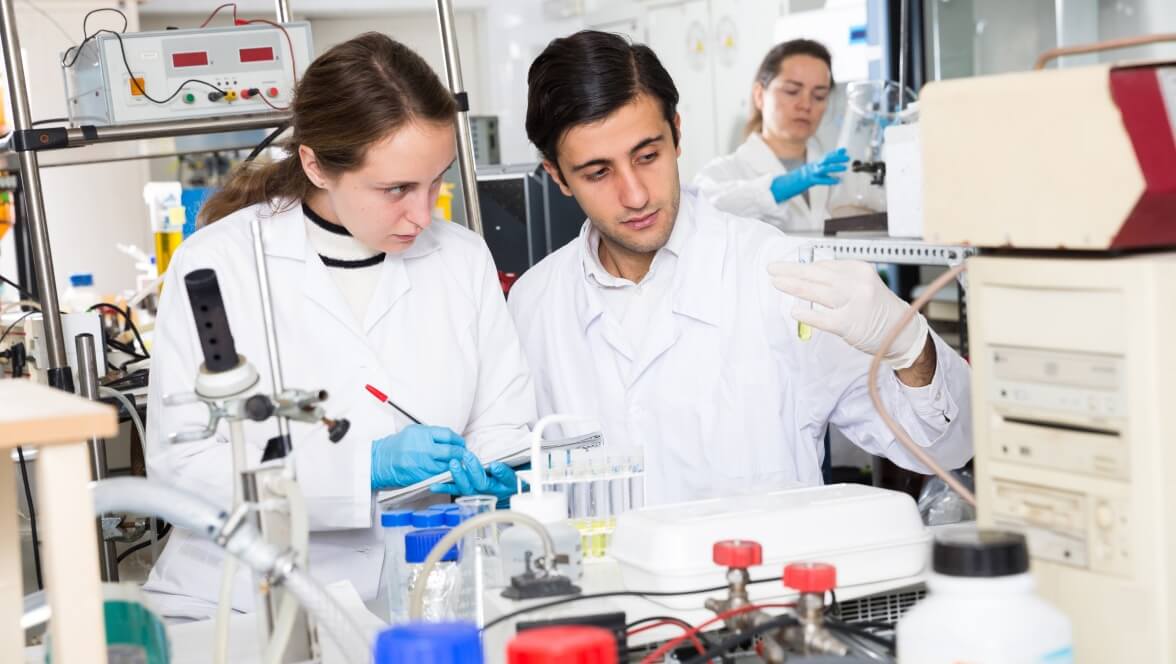 employees working inside the lab and taking notes