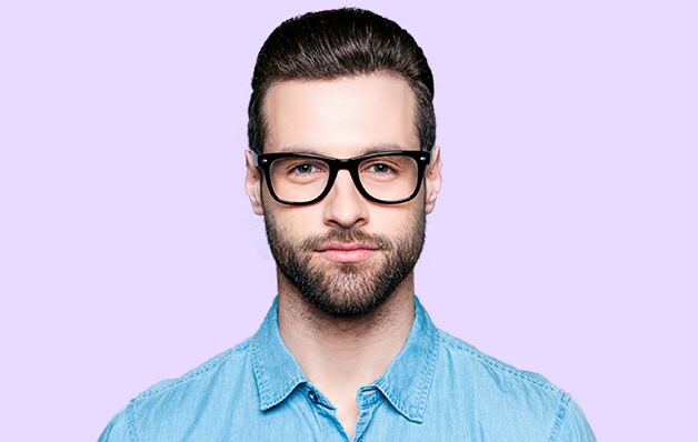 man with glasses in front of purple background