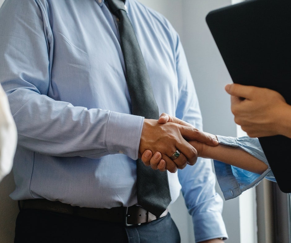 close up of people shaking hands