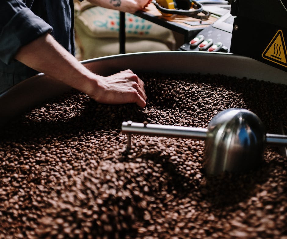 coffee beans being roasted in circular machine