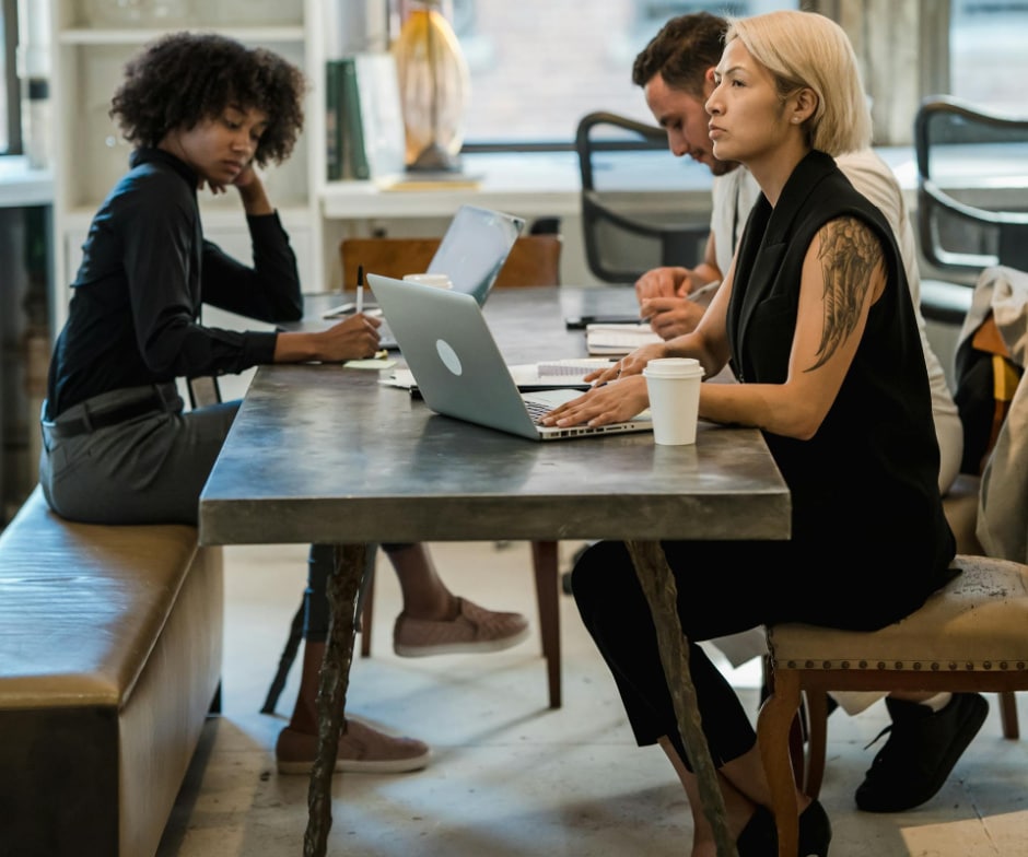 people sitting on table chairs and working
