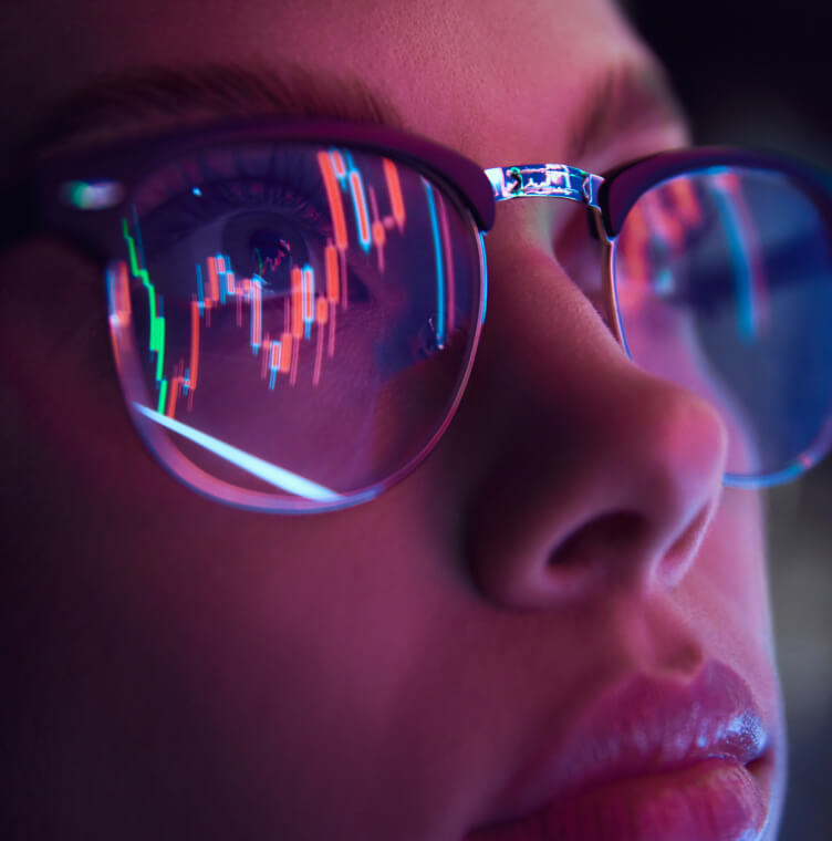 Woman with graph reflected in her glasses
